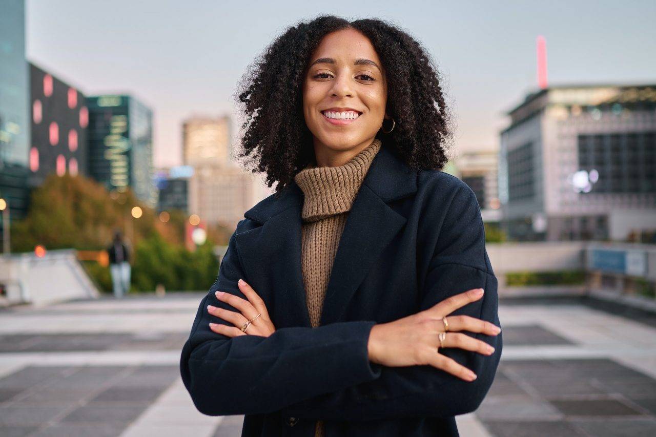 black-woman-portrait-smile-and-arms-crossed-in-the-city-for-vision-ambition-or-career-success-co.jpg